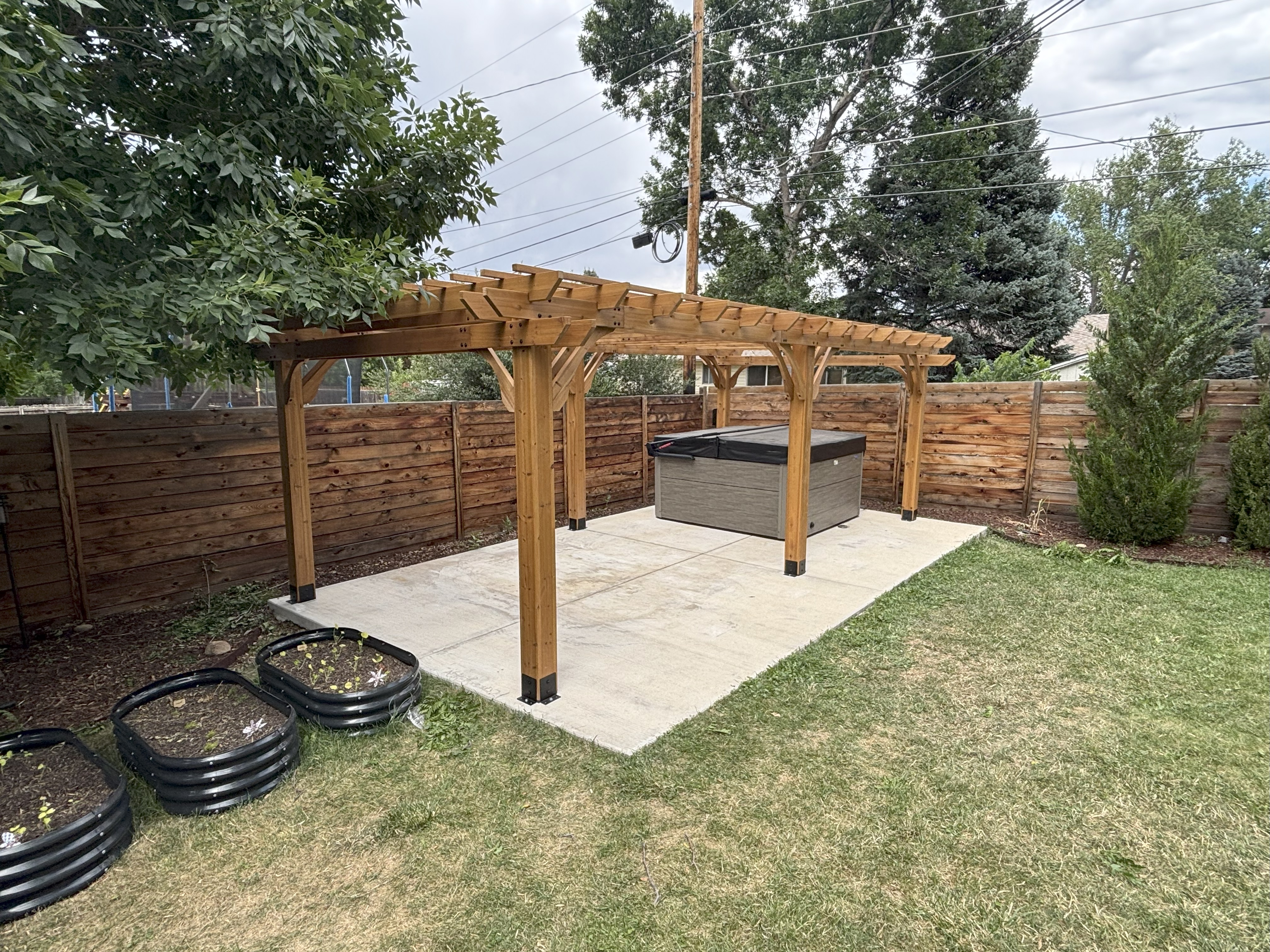 Large 12x20 pergola installation over hot tub area