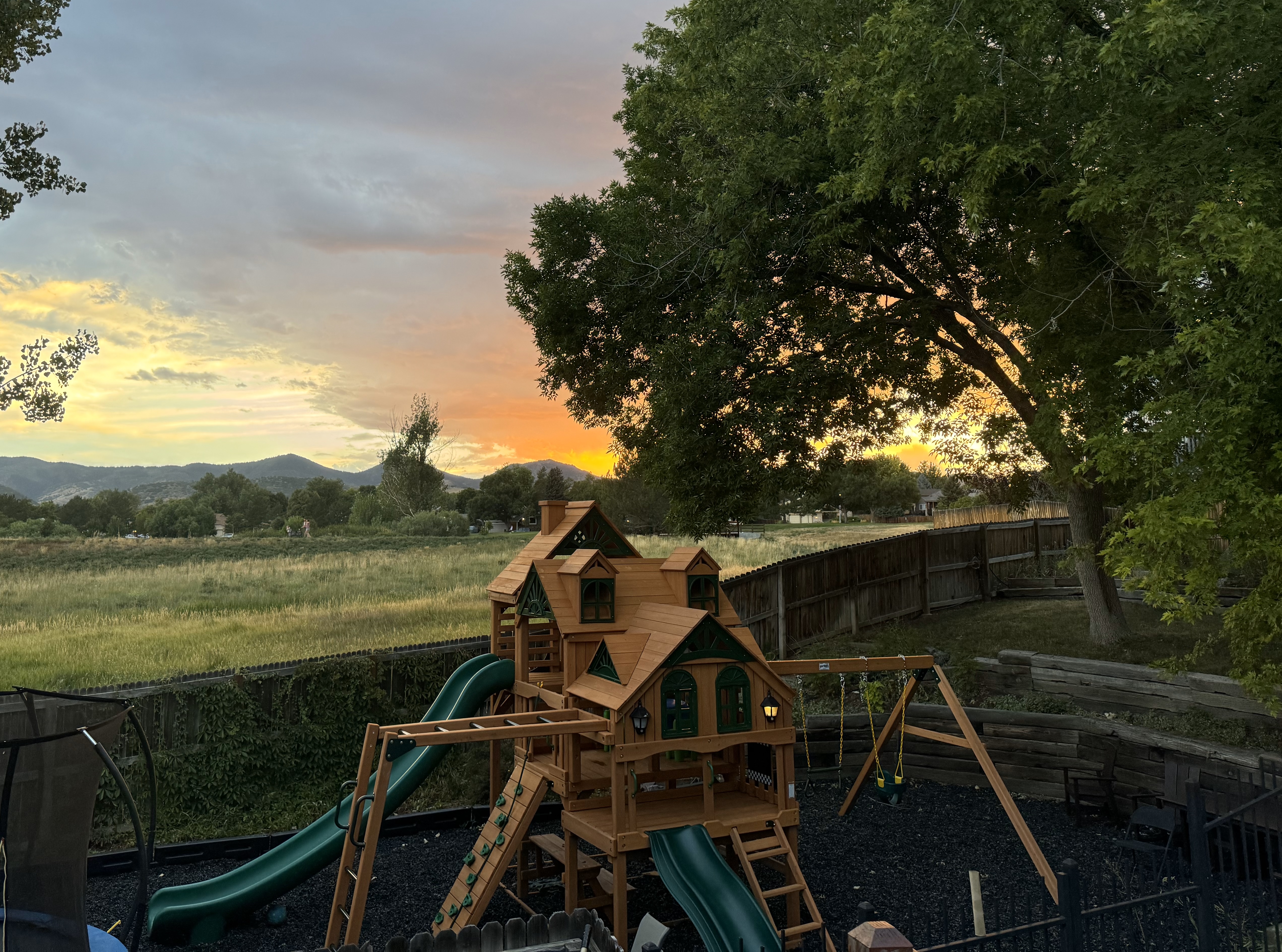 Playset installation at sunset with mountain views