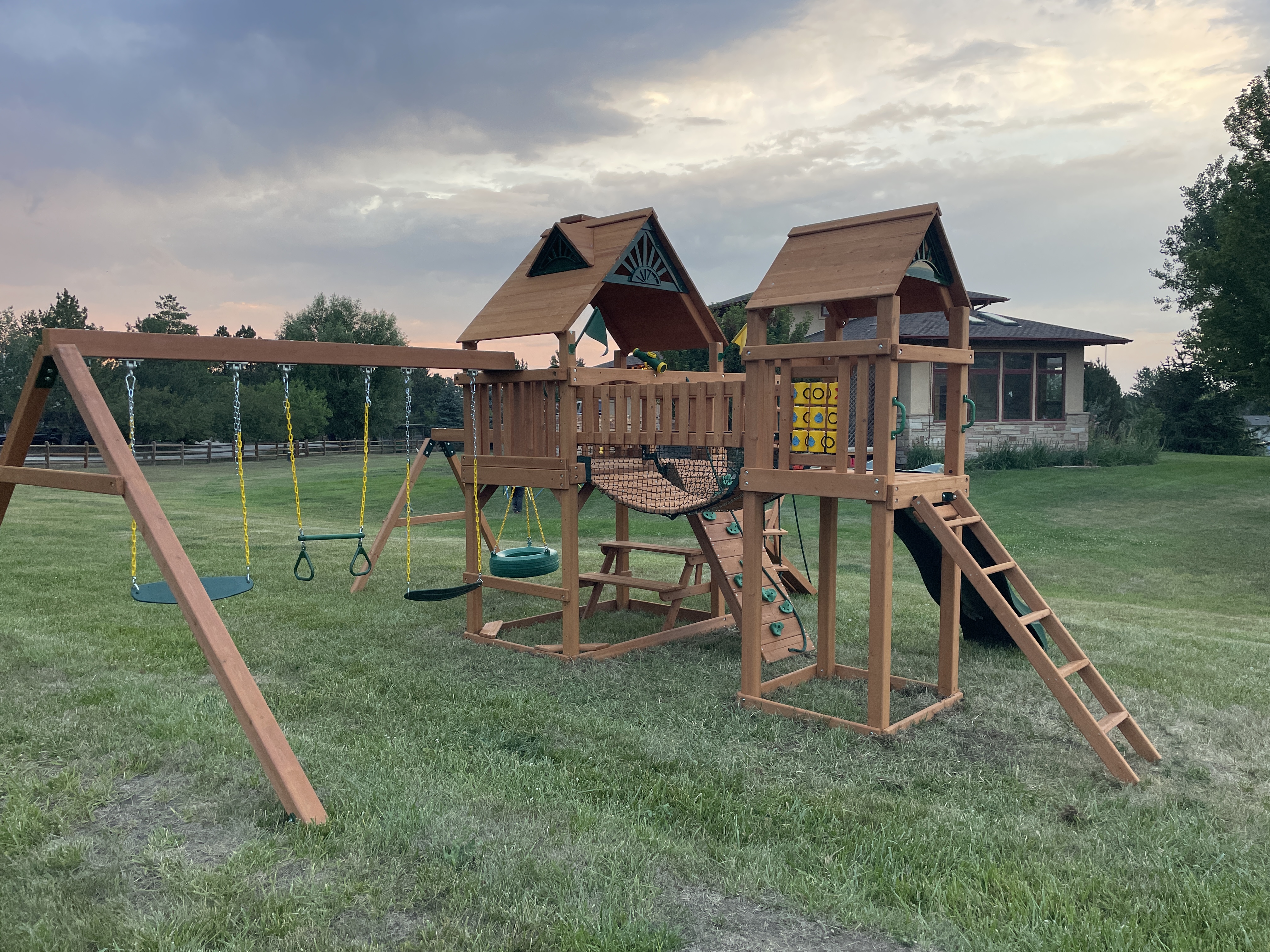 Large playset with swing set in spacious yard